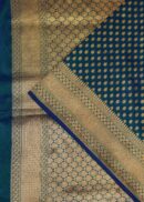 Banarasi silk saree in teal blue colour with all over zari buti and zari fancy border. Comes with a running blouse.