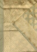 Banarasi silk saree in light grey colour with all over zari buta and zari border. Comes with a running blouse.