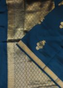 Banarasi silk saree in dark blue colour with all over small zari butis and zari border. Comes with a running blouse.