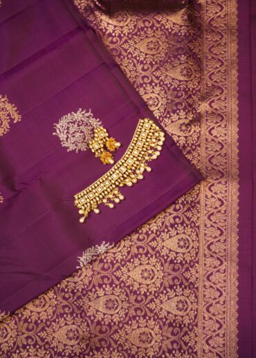 Kanjivaram borderless saree in wine colour. Zari butta in gold and silver, and zari pallu.