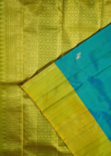 nalli silk, peacock blue and yellowgreen dhupchao. All over small mayuri (mor) butis.